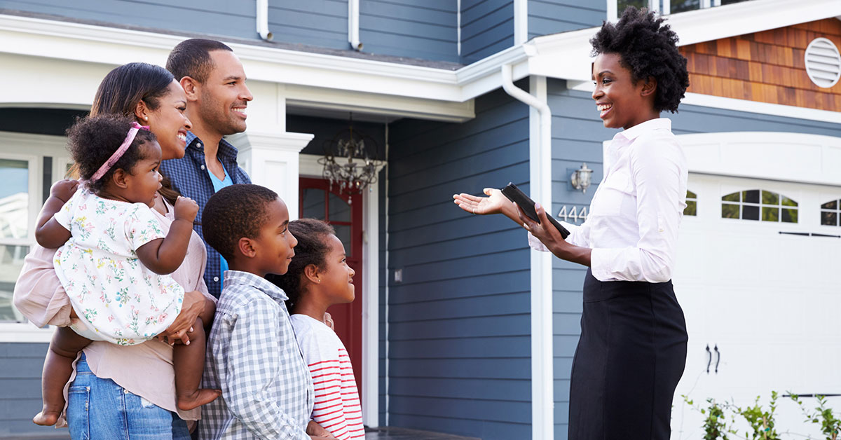 A real estate agent shows a young family a new home