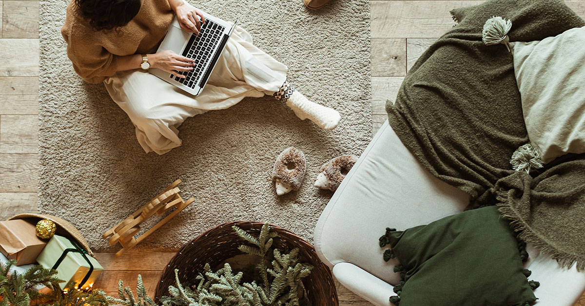 Young woman on her laptop creating her budget for 2022