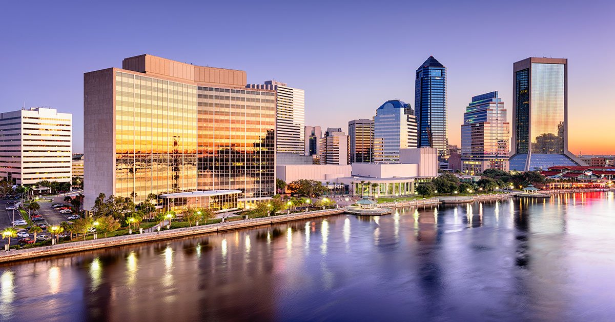 Photo of Jacksonville FL skyline at dusk with view of St. John’s river.