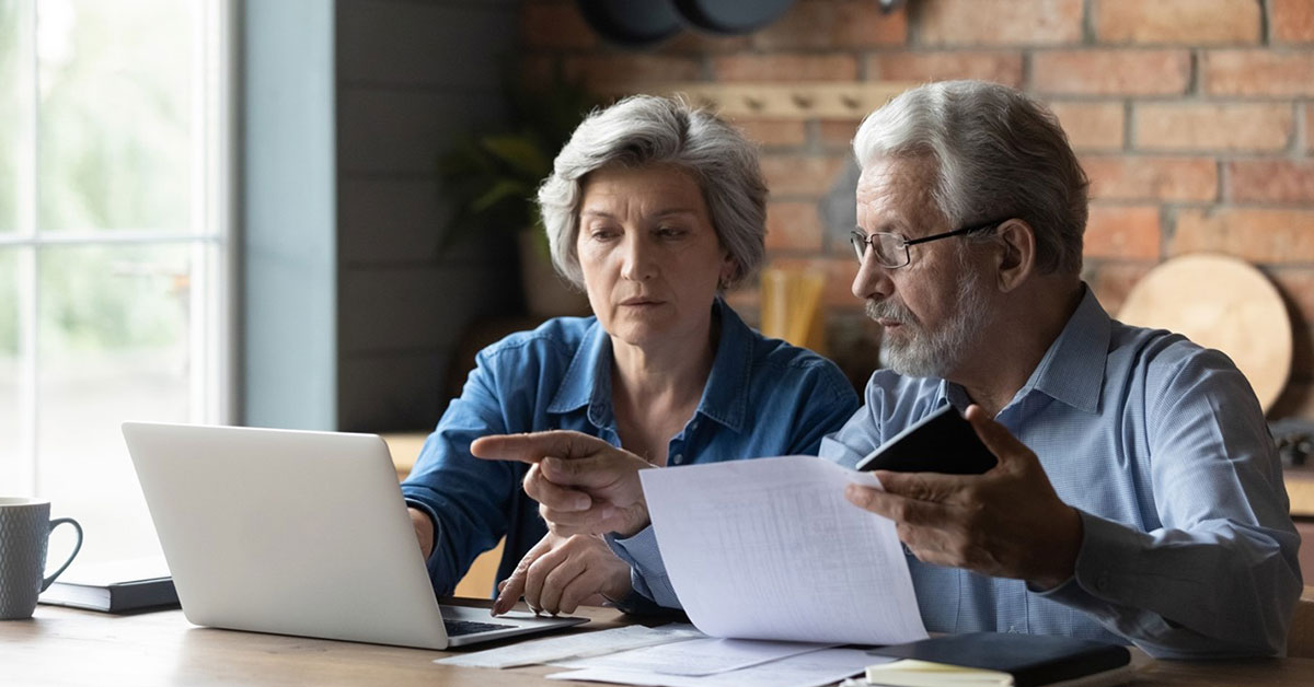 A couple comparing printed tax information to their digital tax records