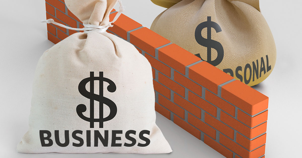 Illustration of brick wall dividing two money bags, one labeled 'Business $' and the other labeled 'Personal $'
