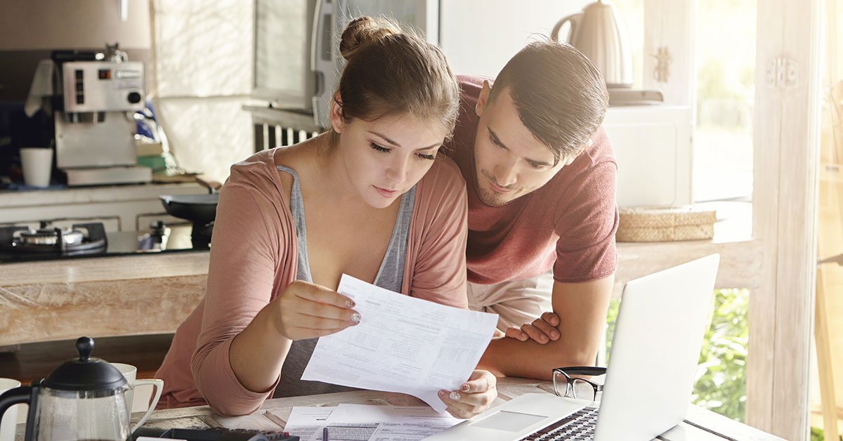 Parents reviewing their finances to determine how much they can save each month