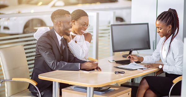 Couple with agent at desk