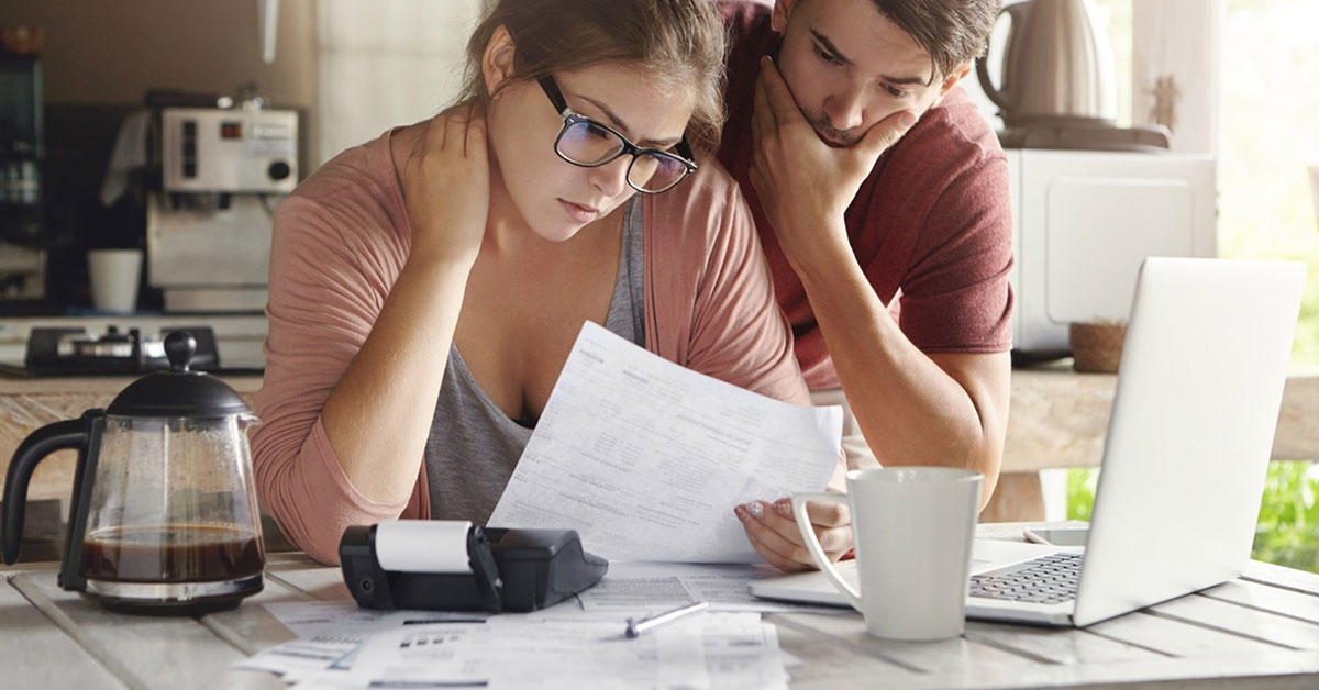 Stressed couple reviewing their tax forms