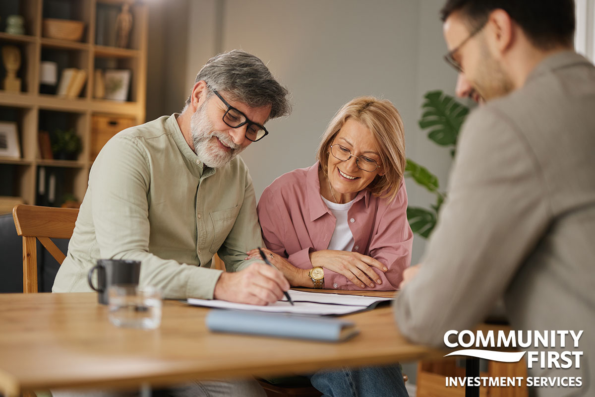 Couple Signing Papers with Agent at Desk