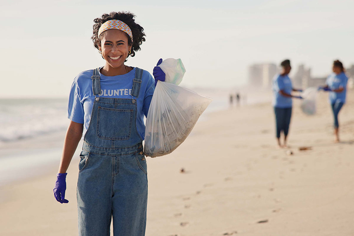 Volunteer on a Beach with Trash Bag