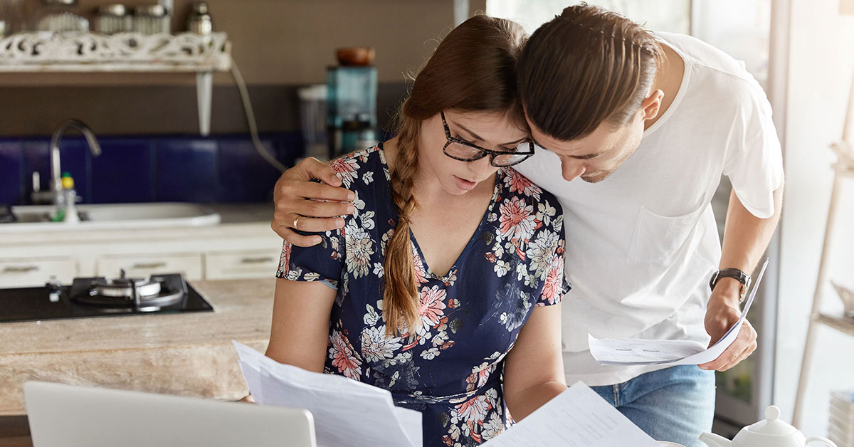 Couple looking at their finances in the kitchen