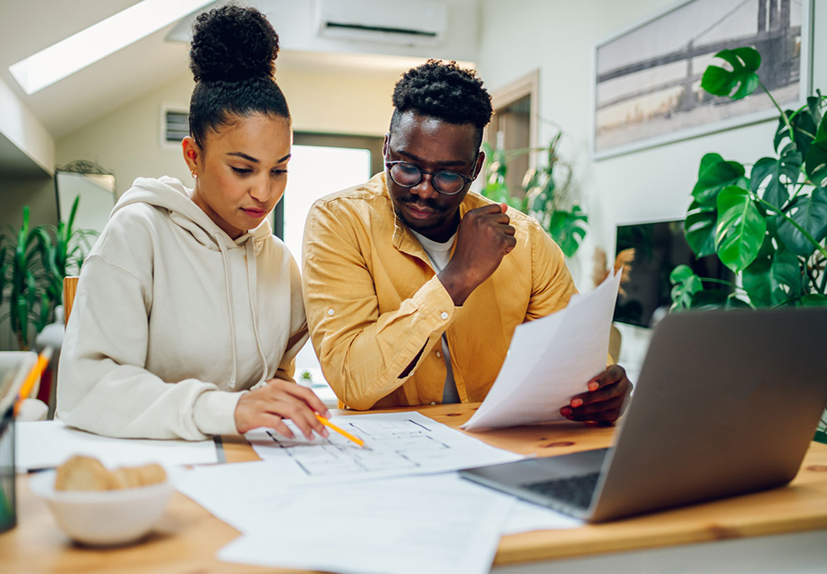 young woman smiles holding phone and card