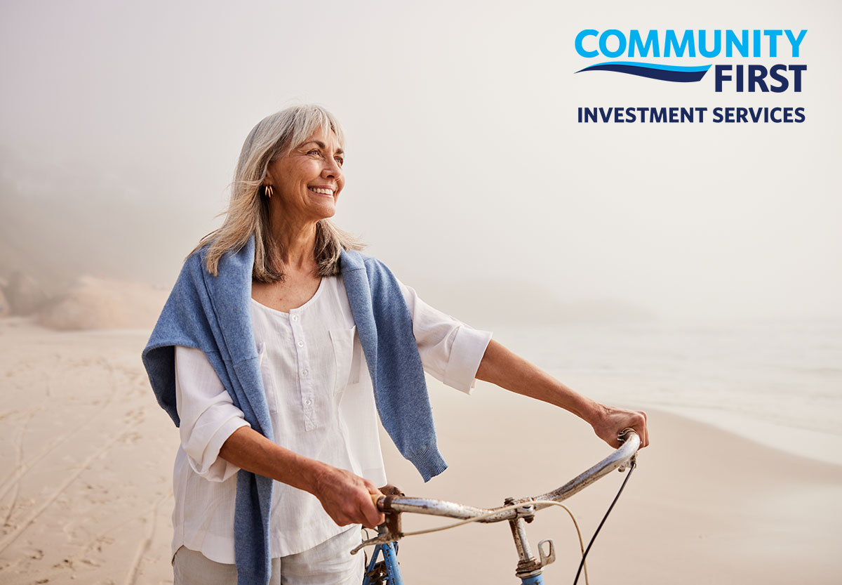 Woman with bicycle on beach