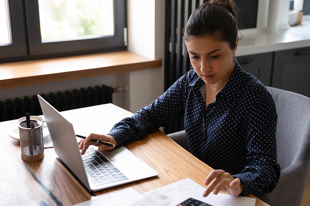 Woman working on a laptop.