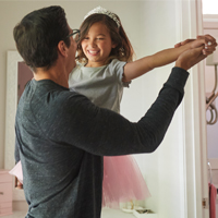 Father and his daughter dancing.