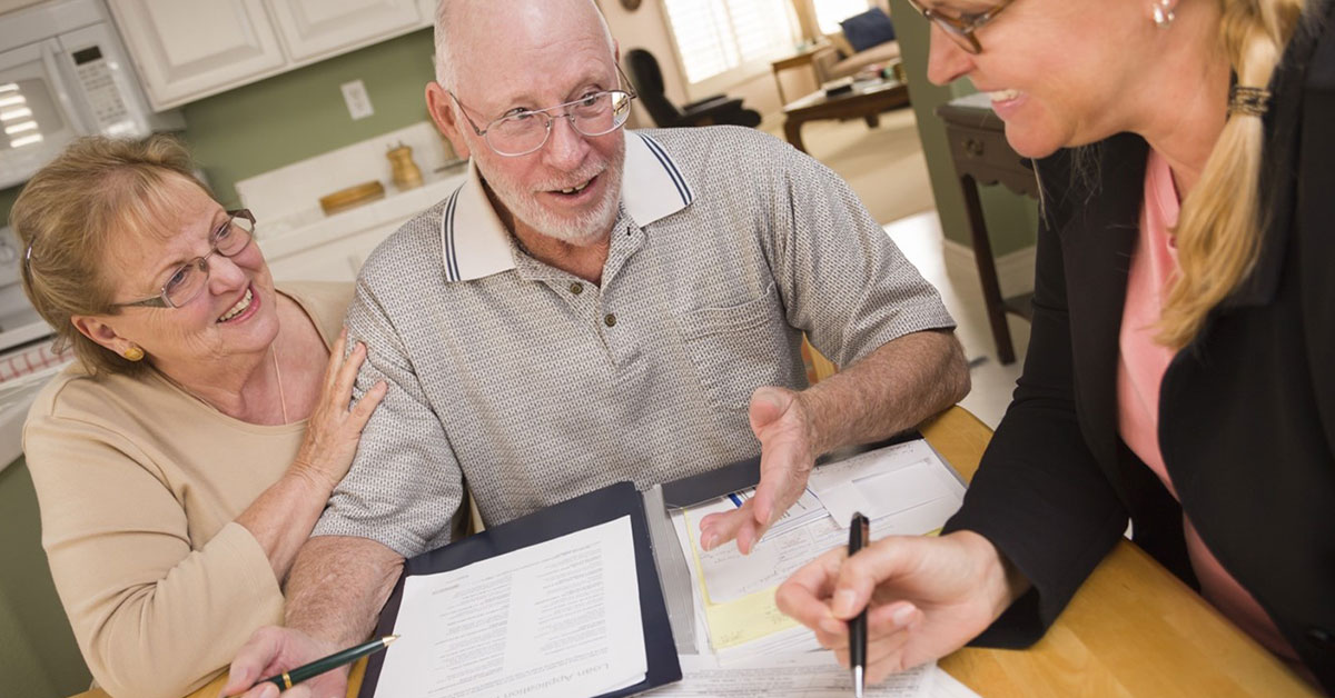 Older couple reviewing the paperwork to refinance their home