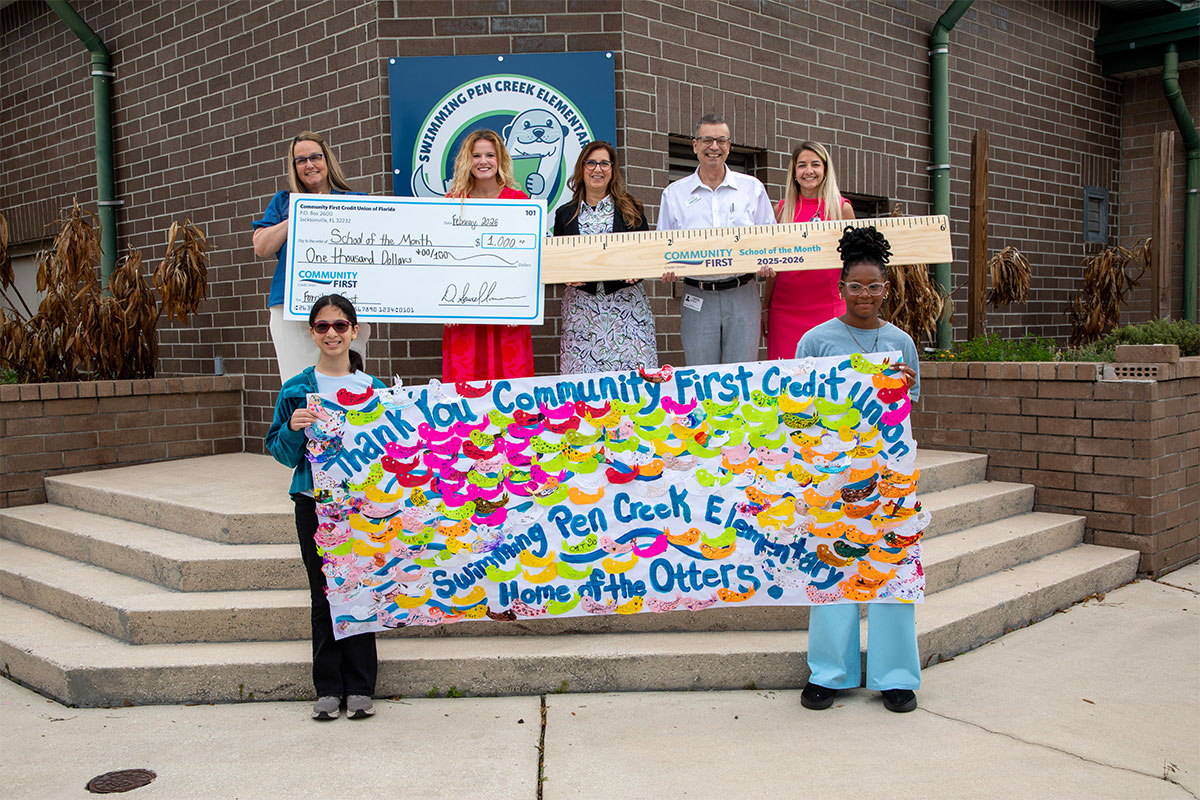 Community First presents check to students and teacher