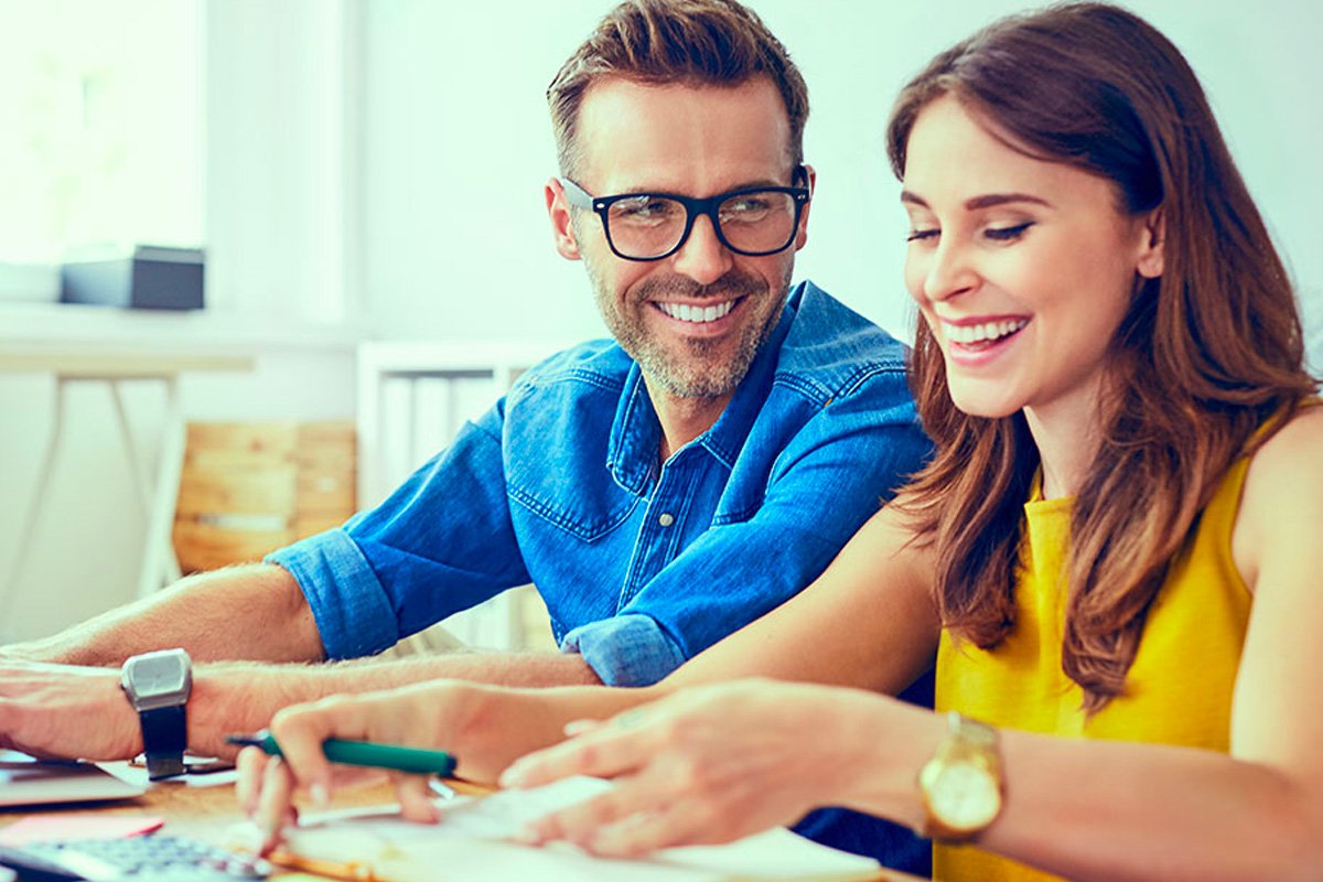 Couple smiling working on finances