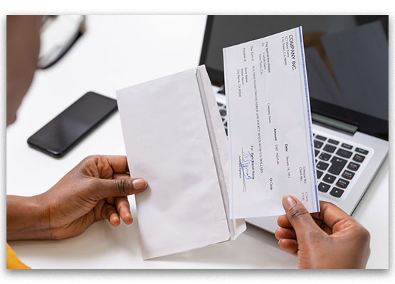 Hand with Payroll Check and Envelope