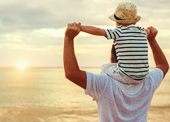 Photo of Man and Child on Shoulders