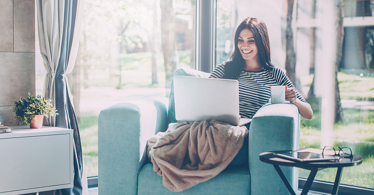 Woman relaxing in a chair while she checks on her passive income