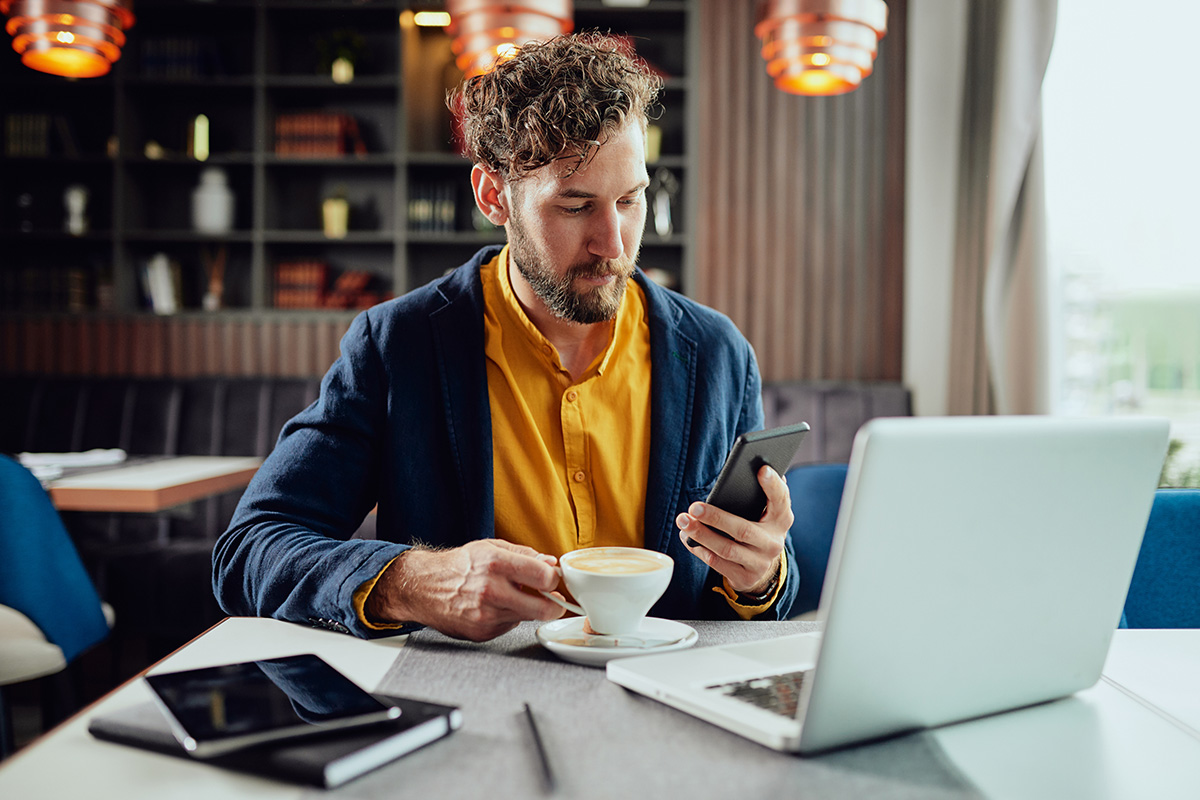 man with laptop and phone