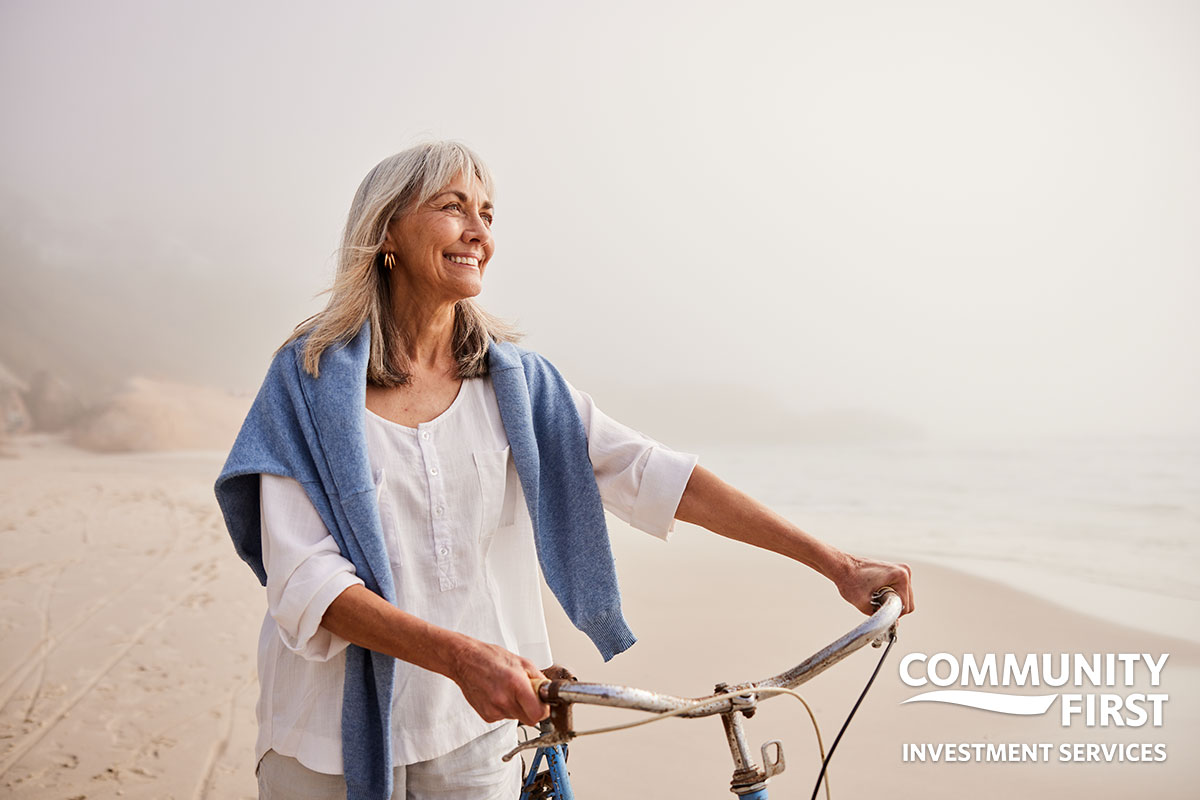 Woman on the beach with her bike
