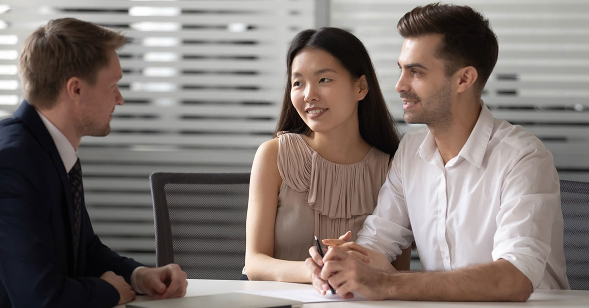 Young couple discussing getting a personal loan at their local credit union