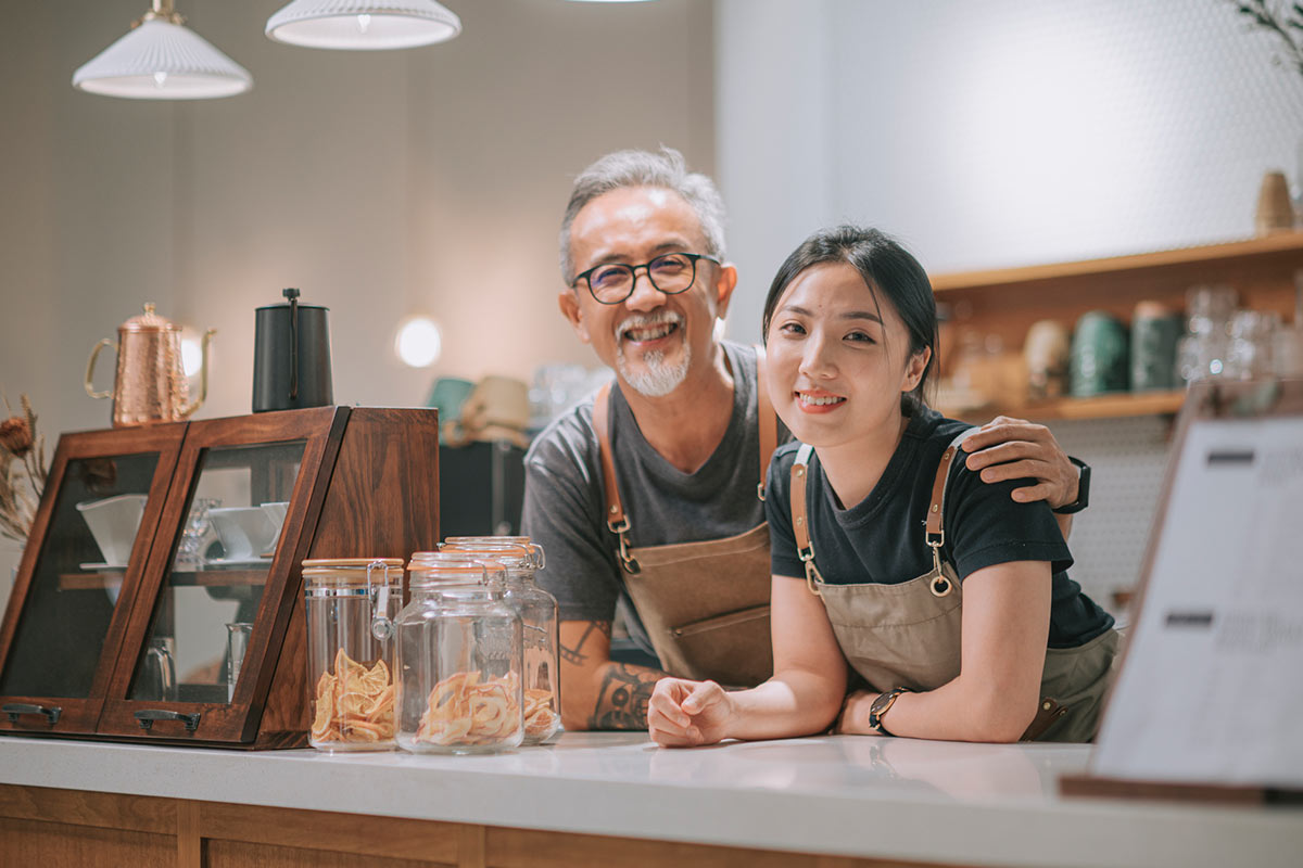 Business owner with daughter at a counter smiling
