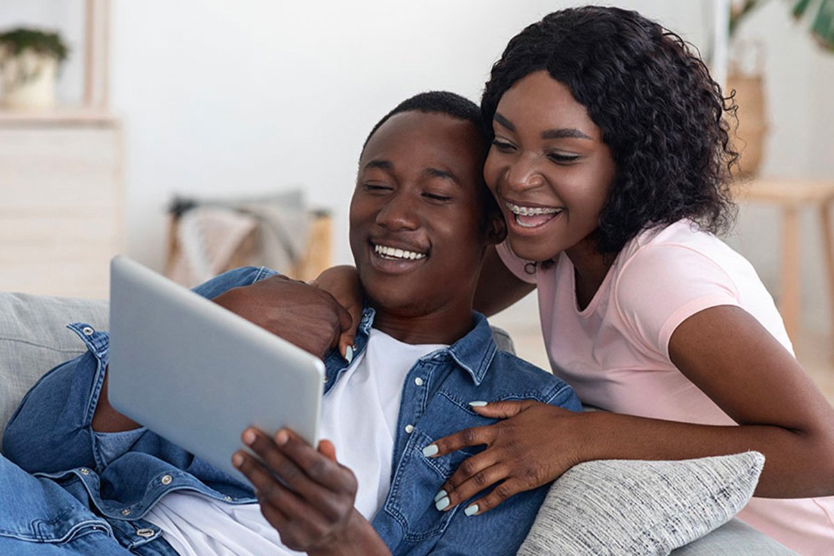 Couple looking at a laptop.