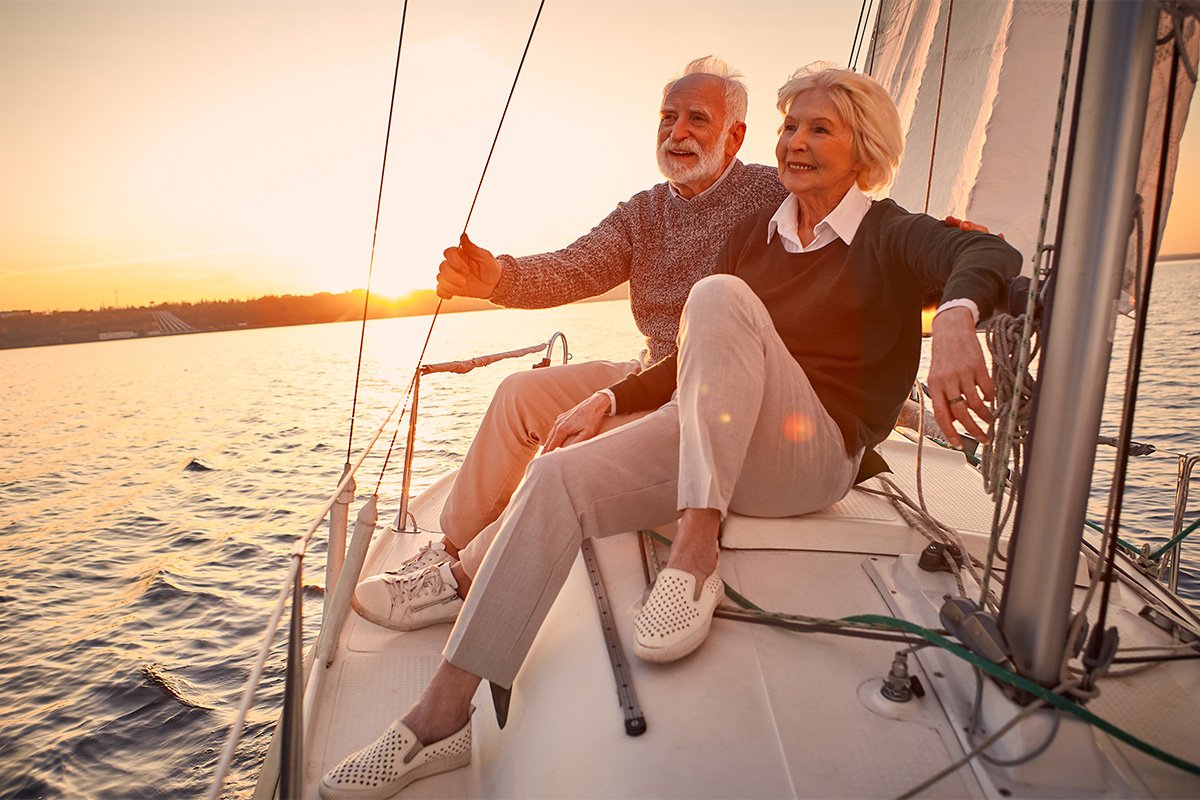 older couple on a boat at sunset