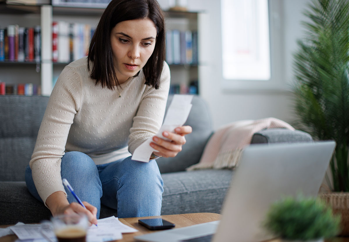 Young woman reviewing receipts