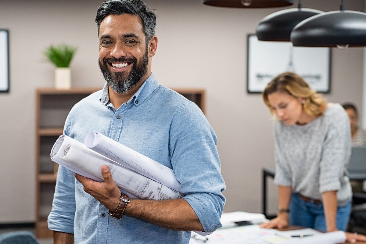 smiling man and woman looking at documents