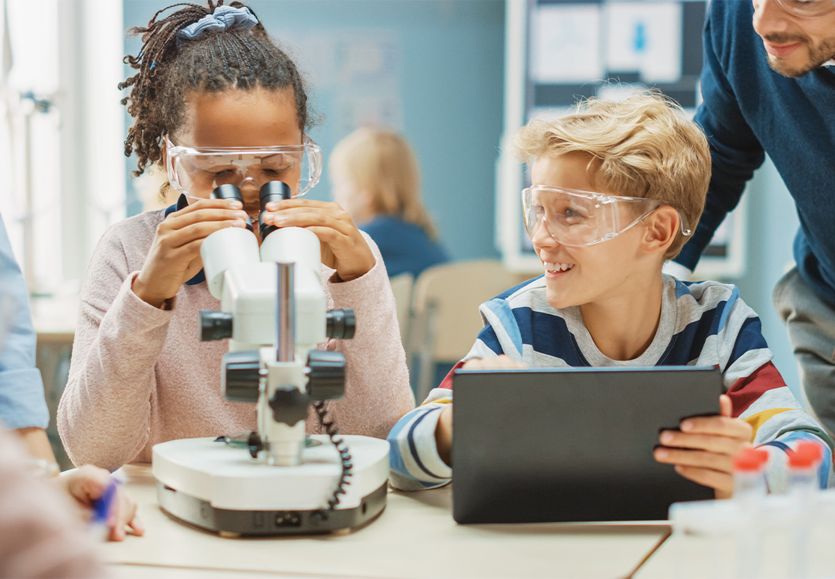 Students with Microscope and Laptop