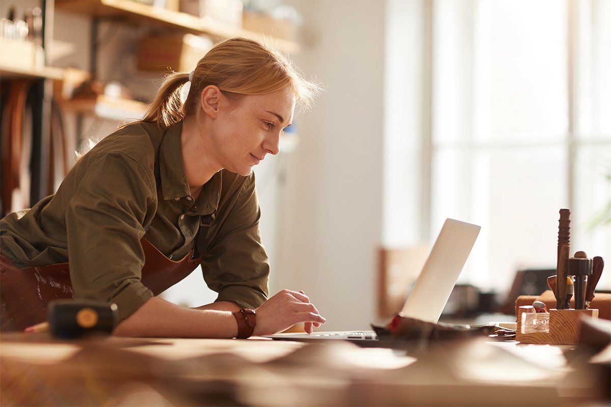 Blonde woman checking her laptop