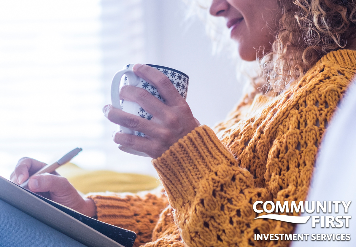 Woman Writing with Coffee in Hand