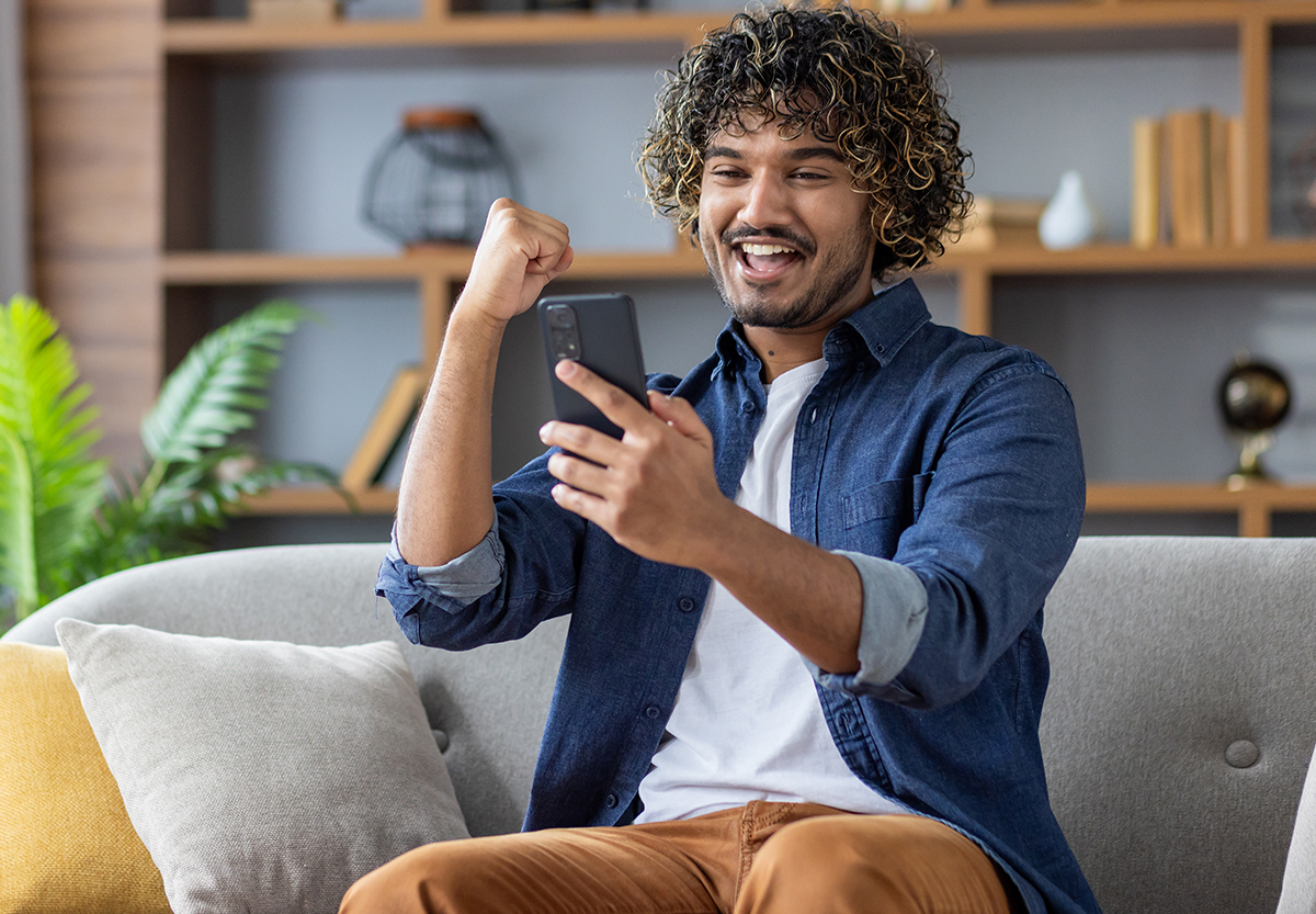 Happy Man Looking at Cell Phone