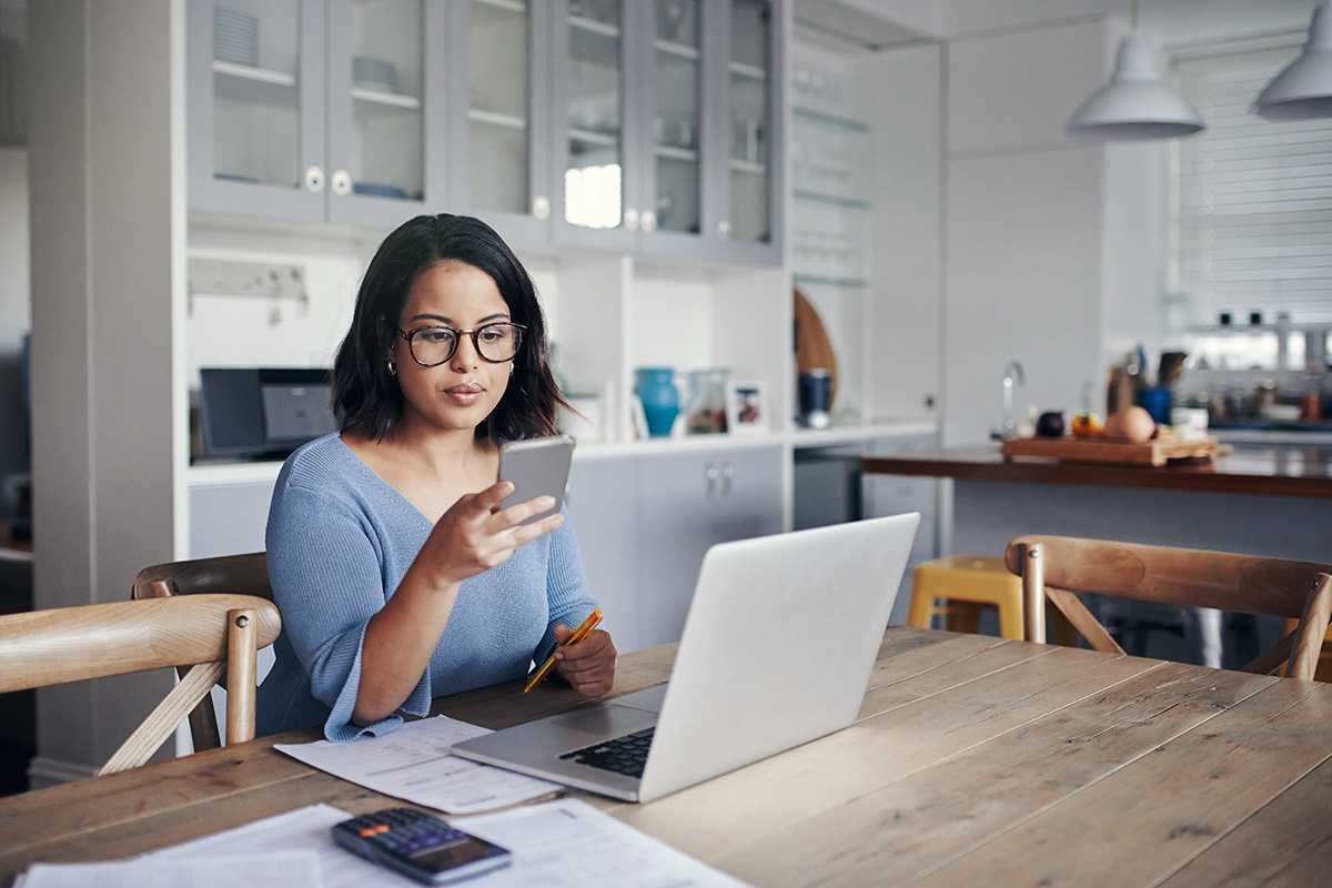 woman with laptop on phone