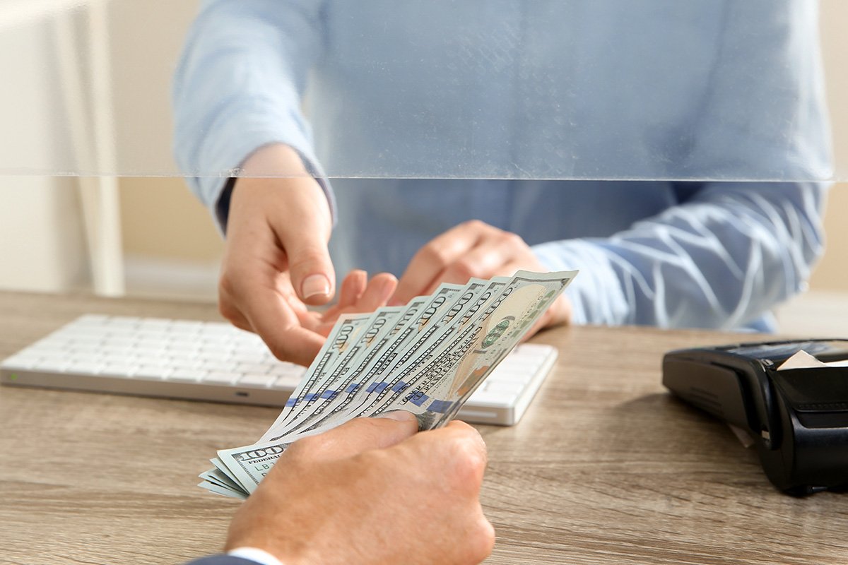 Person depositing money at a ticket office