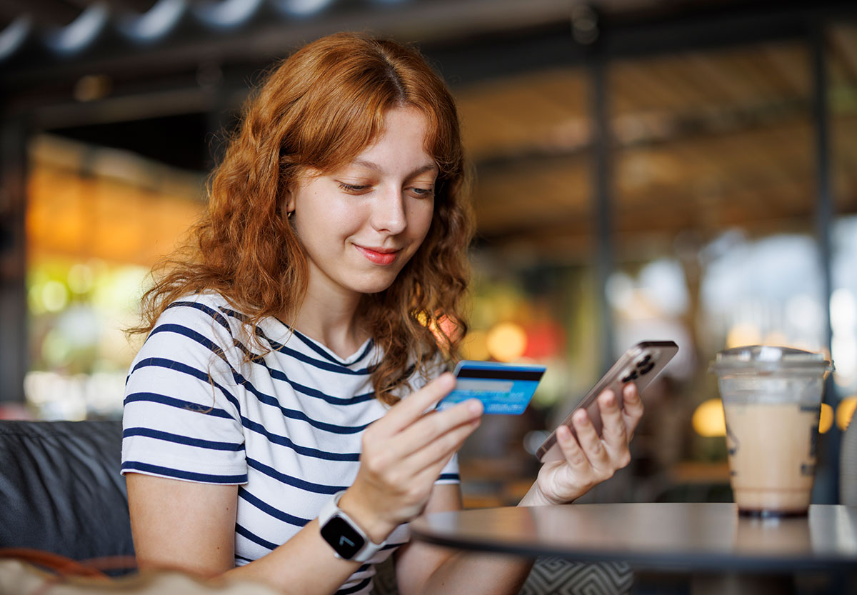 Young Woman with Card and Cell Phone