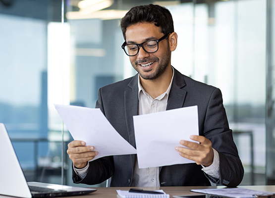 Man Smiling with Paperwork