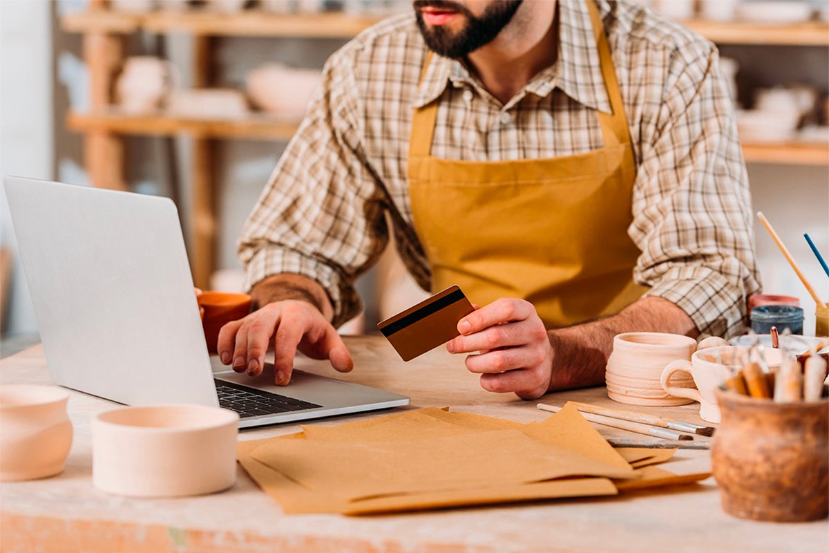 Man using credit card and laptop